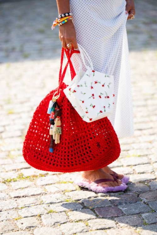 Grece Ghanem wears white skirt, red bag outside Herskind during day three of the Copenhagen Fashion Week SS25 on August 07, 2024 in Copenhagen,...