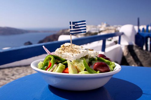greek salad served by the water in santorini, greece - food stock pictures, royalty-free photos & images
