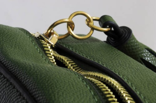 green handbag with unzipped gold colored zipper with three metal rings attached - fashion stock pictures, royalty-free photos & images