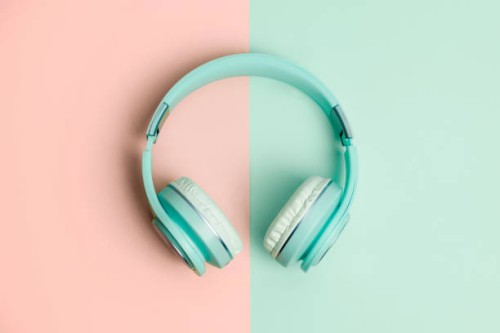 green headphones on a green and salmon background - fashion stock pictures, royalty-free photos & images