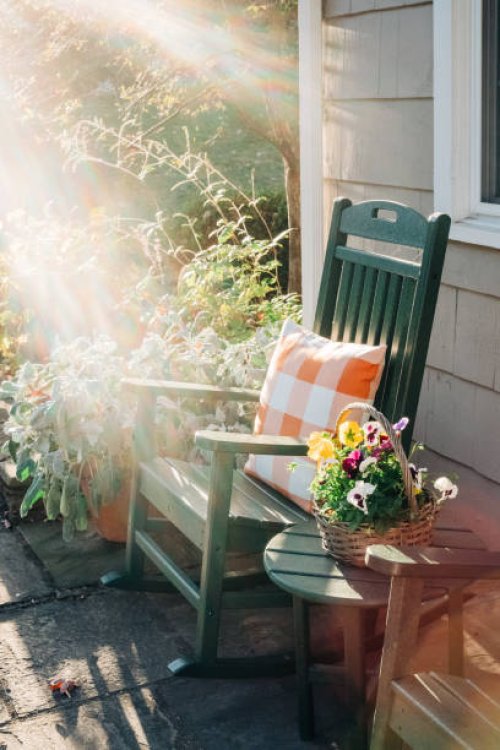 green rocking chair on a sunlit patio - garden decoration stock pictures, royalty-free photos & images