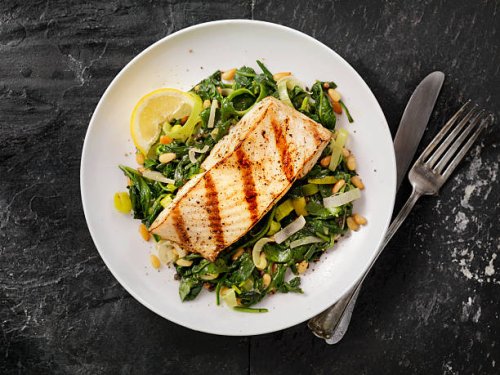 grilled halibut with spinach, leeks and pine nuts - food stock pictures, royalty-free photos & images