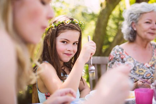 grl sitting between mother and grandmother at a garden table - garden decoration stock pictures, royalty-free photos & images