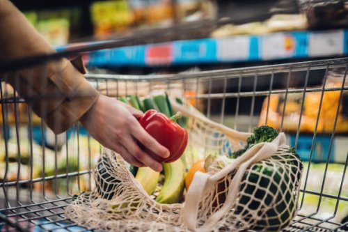 grocery shopping with reusable shopping bag at supermarket - food stock pictures, royalty-free photos & images