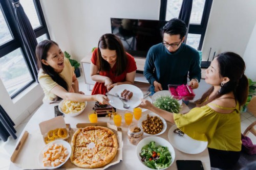 group of asian chinese man and woman having a birthday party at home - junk food stock pictures, royalty-free photos & images