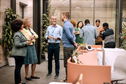 group of business people having casual conversation while on a refreshment break - food stockfoto's en -beelden