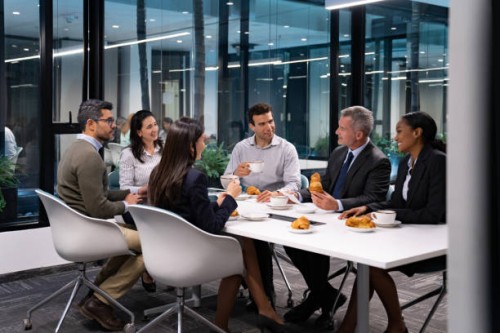 group of business people in a meeting eating breakfast - food stock pictures, royalty-free photos & images