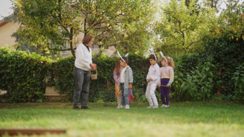 group of children playing egg and spoon race outdoors - garden decoration stock pictures, royalty-free photos & images
