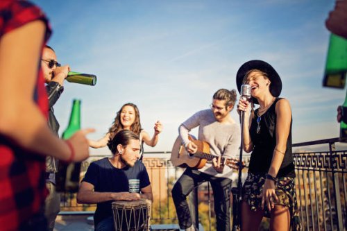 group of friends are celebrating with a concert on the roof terrace - concert stock pictures, royalty-free photos & images