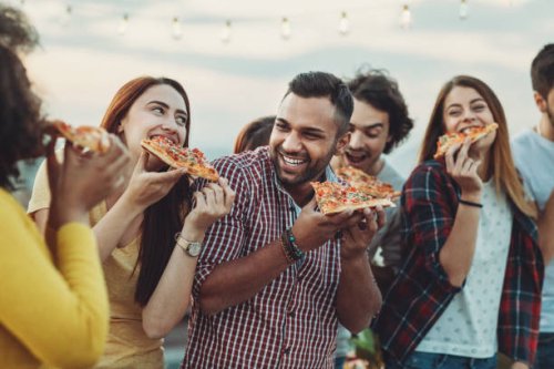 group of friends eating pizza - junk food stock pictures, royalty-free photos & images