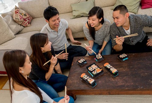 group of friends having sushi - junk food stock pictures, royalty-free photos & images