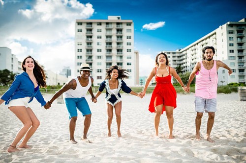 group of friends jumping on the beach - concert stock pictures, royalty-free photos & images