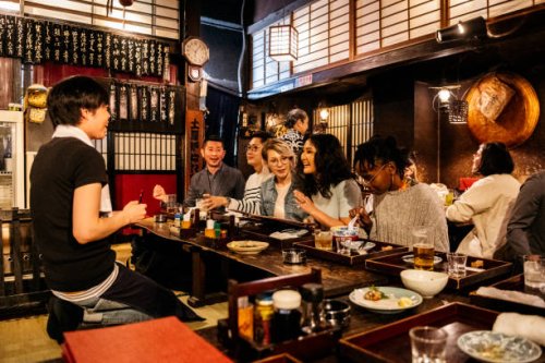 group of friends ordering food in japanese izakaya - food stock pictures, royalty-free photos & images