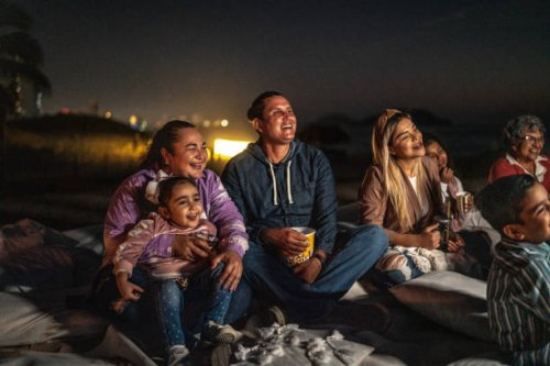 group of people watching a movie outdoors - concert stock pictures, royalty-free photos & images