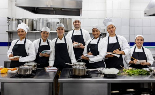 group of students smiling in a cooking class - food stock pictures, royalty-free photos & images