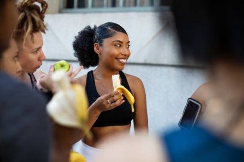 group of women eating banana after workout session - food stock pictures, royalty-free photos & images