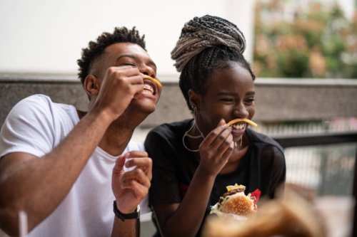 group of young people having fun in a restaurant - junk food stock pictures, royalty-free photos & images