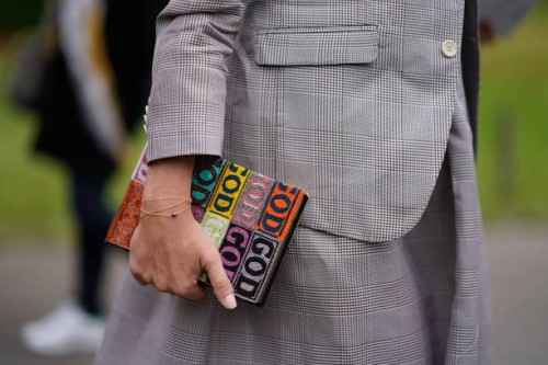 Guest holds a color book , outside Leonard, during Paris Fashion Week Womenswear Spring/Summer 2018, on October 2, 2017 in Paris, France.