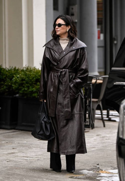 Guest is seen waring a brown trench coat, tan sweater, black bag and black sunglasses outside the Kallmeyer show during NYFW F/W 2025 on February 11,...