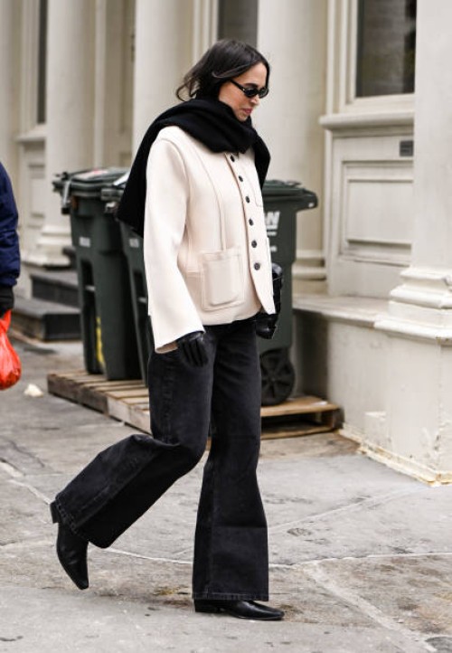 Guest is seen waring a white jacket, black pants, black shoes and black scarf outside the Kallmeyer show during NYFW F/W 2025 on February 11, 2025 in...