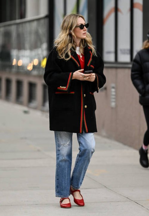 Guest is seen wearing a black and red Gucci jacket, blue jeans and red shoes with black sunglasses outside the Jason Wu show during NYFW F/W 2024 on...