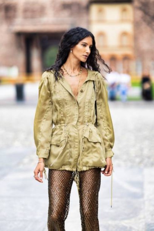 Guest is seen wearing a fishnet paillettes pants, and khaki jacket outside the Alberta Ferretti show during Milan Fashion Week Womenswear...