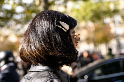 Guest is seen wearing a Miu Miu jacket and hair clips outside the Miu Miu show during Womenswear Spring/Summer 2025 as part of Paris Fashion Week on...
