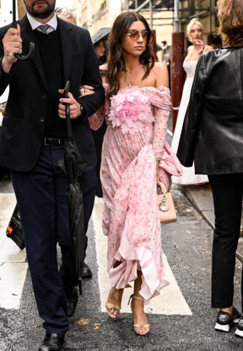 Guest is seen wearing a pink floral Giambattista Valli dress and tan bag outside the Giambattista Valli show during Womenswear Spring/Summer 2025 as...