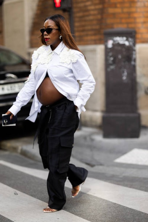 Guest is seen wearing a white button shirt with embellishment and cargo pants outside Dries Van Noten show during the Womenswear Spring/Summer 2024...