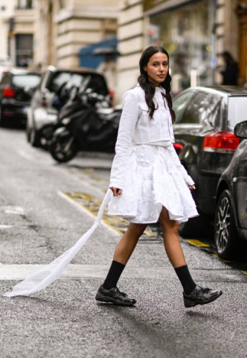 Guest is seen wearing a white Cecilie Bahnsen top and skirt with black shoes outside the Cecilie Bahnsen show during Womenswear Spring/Summer 2025 as...
