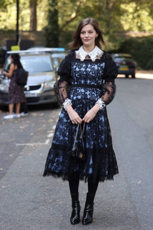 Guest wearing black laced dress with white lace collar and cuffs attends Bora Aksu at the Goodenough College during London Fashion Week September...