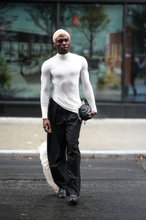 Guest wears a black turtleneck top, black pants, a bag, leather split-toeshoes, outside Helmut Lang, New York Fashion Week, during on September 09,...