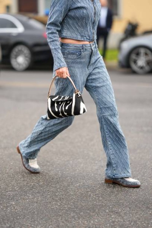 Guest wears a blue faded denim embroidered checkered pattern zipper jacket, matching blue faded denim embroidered checkered pattern large pants, a...