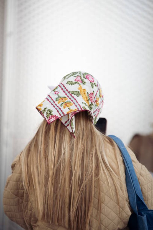 Guest wears a head scarf outside Munthe during the Copenhagen Fashion Week AW24 on February 1, 2024 in Copenhagen, Denmark.