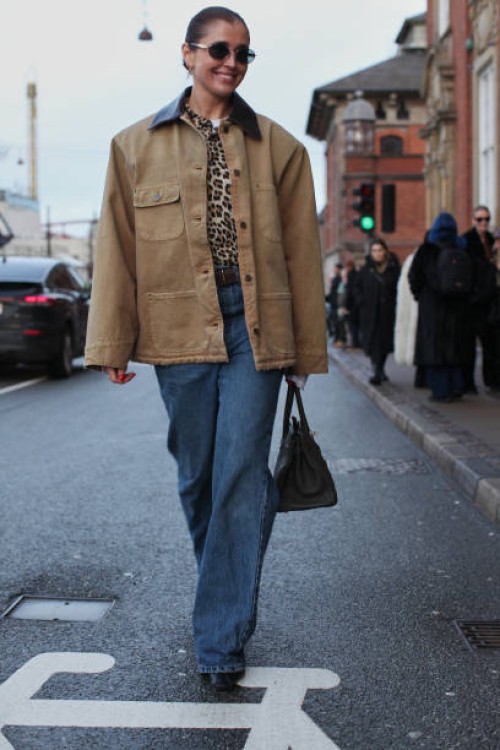 Guest wears a Prada X Carhartt Work Jacket at Deadwood during the Copenhagen Fashion Week Autumn/Winter 2025 on January 28, 2025 in Copenhagen,...