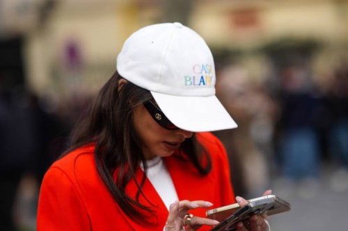 Guest wears a white Casablanca cap, Gucci sunglasses, outside Casablanca, during the Womenswear Fall/Winter 2024/2025 as part of Paris Fashion Week...
