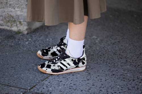 Guest wears Adidas sneaker with animal cow print outside Lueder during Berlin Fashion Week SS26 on July 02, 2025 in Berlin, Germany.