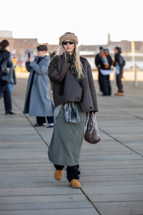 Guest wears beige head band, brown bag, green skirt, bag outside OpéraSport during the Copenhagen Fashion Week AW24 on January 31, 2024 in...