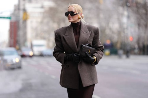 Guest wears black Altuzarra sunglasses, gold earrings, deep dark brown turtleneck long sleeve form fitting midi dress, dark brown oversized double...