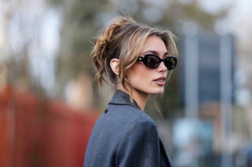 Guest wears black sunglasses, dark gray blazer coat, outside Diesel, during the Milan Fashion week Women's Fall/Winter 2025-2026 on February 26, 2025...