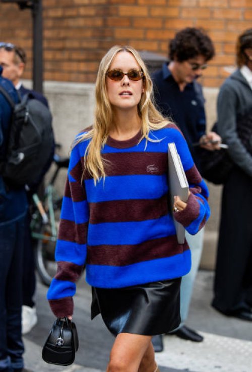 Guest wears blue burgundy striped sweater outside Lacoste during Womenswear Spring/Summer 2025 as part of Paris Fashion Week on October 01, 2024 in...