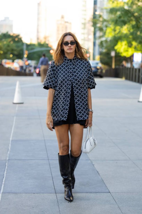Guest wears checkered top, black dress outside Michael Kors during New York Fashion Week on September 10, 2024 in New York City.