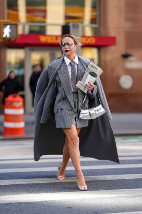 Guest wears clean transparent glasses, white buttoned up long sleeve shirt, light gray tie, dark gray white pinstripe oversized double breasted...