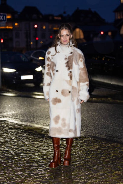 Guest wears coat with cow print outside Remain during the Copenhagen Fashion Week AW24 on January 30, 2024 in Copenhagen, Denmark.