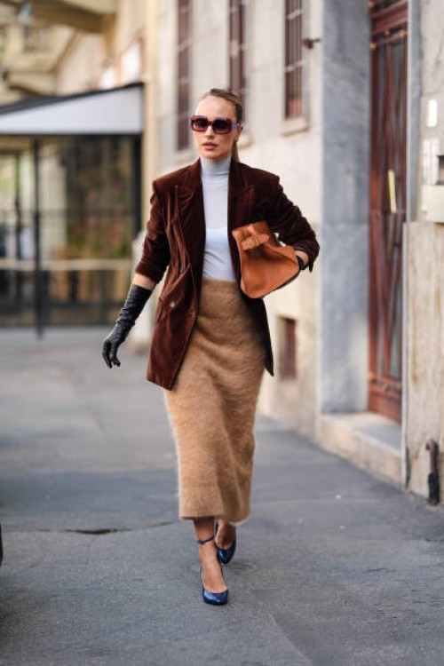 Guest wears dark brown, light blue turtle neck, dark brown velvet blazer jacket, light brown fluffy midi skirt, dark brown leather bag, shiny black...
