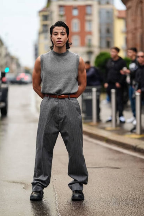 Guest wears dark gray sweater vest, dark brown leather belt, dark gray lined baggy loose pants, shiny black platform boots, outside Onitsuka Tiger,...