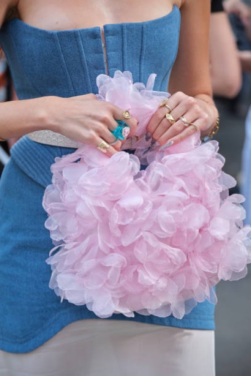Guest wears denim corsen and flower organza bag during the Milan Fashion Week Menswear Spring/Summer 2025 on September 21, 2024 in Milan, Italy.