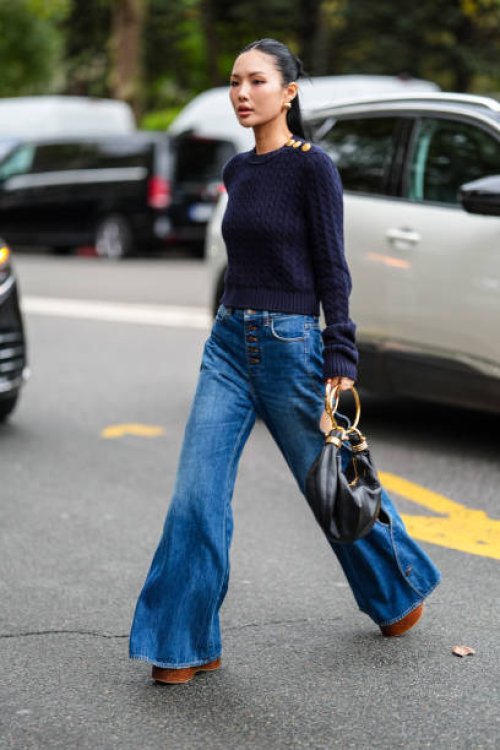 Guest wears gold earrings, navy blue knit sweater with gold detail, navy blue denim jean cutout pants, dark brown Chloe platform shoes, shiny black...