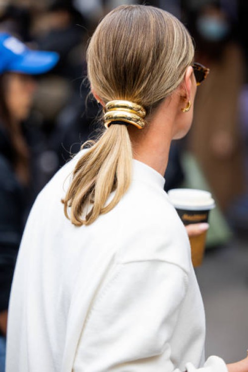 Guest wears golden hair clip outside Lacoste during Womenswear Spring/Summer 2025 as part of Paris Fashion Week on October 01, 2024 in Paris, France.