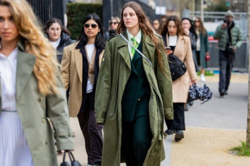 Guest wears green coat outside Lacoste during the Womenswear Fall/Winter 2024/2025 as part of Paris Fashion Week on March 05, 2024 in Paris, France.